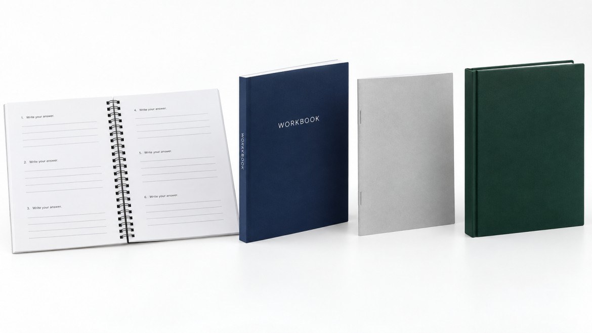 Four workbooks side by side showing spiral bound open flat, perfect bound with a printed spine, a stapled saddle stitch guide and a hardcover edition